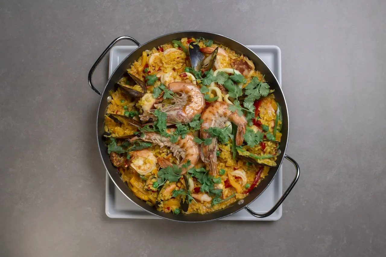 Tacho rico de arroz caldoso com camarões, amêijoas, mexilhões e coentros